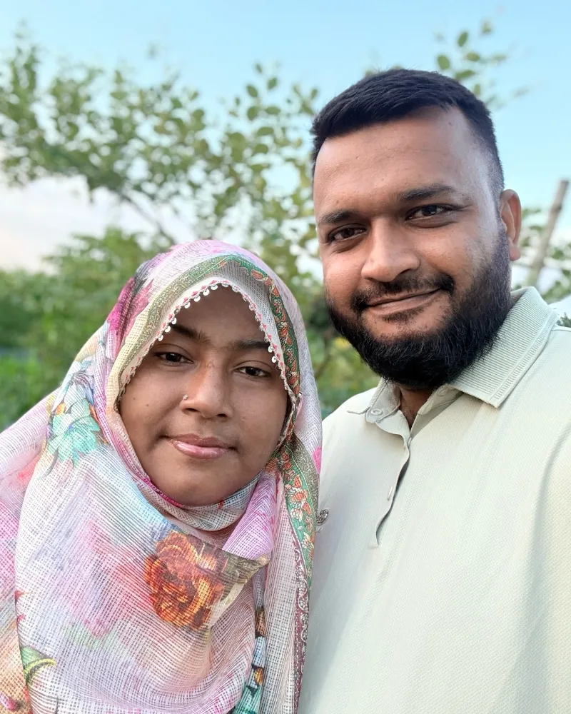 Shameem and a family member smiling outdoors
