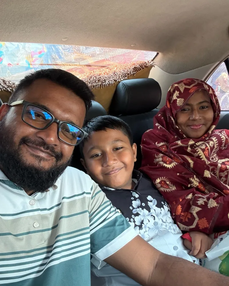 A family selfie in the back of a car